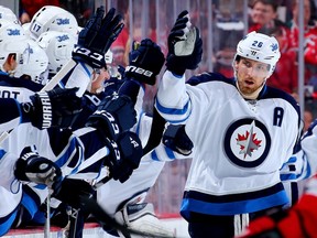 Blake Wheeler is congratulated by his teammates after scoring the Jets second goal of the game Friday night in New Jersey.