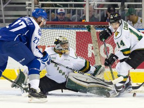 London Knights goaltender Tyler Parsons keeps his eyes on the puck as Sudbury Wolves forward Matt Schmalz and Knights defenceman Brandon Crawley scramble for it during their Ontario Hockey League game at Budweiser Gardens on Friday. (CRAIG GLOVER, The London Free Press)