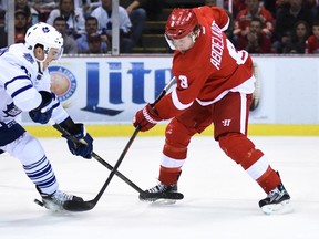 Red Wings left wing Justin Abdelkader (right) shoots past Maple Leafs defenceman Scott Harrington (left) to score a goal during the first period at Joe Louis Arena in Detroit on Friday, Oct. 9, 2015. (Tim Fuller/USA TODAY Sports)
