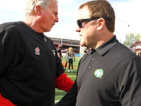 Calgary Stampeders coach John Hufnagel shakes with Edmonton Eskimos coach Chriis Jones after the win in second half CFL action at McMahon stadium in Calgary on Monday September 7, 2015. Darren Makowichuk/Calgary Sun/Postmedia Network