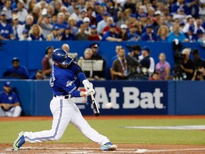 Blue Jays batter Josh Donaldson hits a home run against the Rangers during Game 2 of the American League Division Series in Toronto on Friday, Oct. 9, 2015. (Stan Behal/Toronto Sun/Postmedia Network)