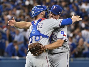 Rangers catcher Chris Gimenez (38) celebrates with relief pitcher Ross Ohlendorf after defeating the Blue Jays in Game 2 of the ALDS in Toronto on Friday, Oct. 9, 2015. (Nick Turchiaro/USA TODAY Sports)