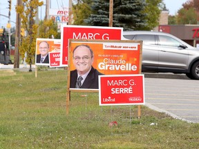 Election signs dot the front of a strip mall in Val Caron in Sudbury, Ont. on Thursday October 8, 2015. Gino Donato/Sudbury Star/Postmedia Network