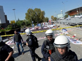 Police forensic experts examine the scene following explosions during a peace march in Ankara, Turkey, October 10, 2015. At least 30 people were killed when twin explosions hit a rally of hundreds of pro-Kurdish and leftist activists outside Ankara's main train station on Saturday in what the government described as a terrorist attack, weeks ahead of an election. REUTERS/Stringer