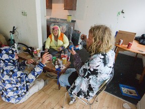 Former clients of Keith Charles smoke marijuana using a pop can in a Hilton Place residence in London. Derek Ruttan/The London Free Press/Postmedia Network
