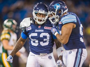 Toronto Argonauts Greg Jones (left) against the Edmonton Eskimos  during first half CFL action at the Rogers Centre in Toronto, Ont. on Saturday October 4, 2014. Ernest Doroszuk/Toronto Sun/QMI Agency