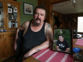Dan Joubert sits in his home near Richer, Man., on Fri., Oct. 9, 2015, with a portrait of his son Robert, who was killed by a drunk driver in June 2012. Dan Jolicoeur plead guilty to driving with a blood-alcohol concentration over .08 causing death on Wednesday. (Kevin King/Winnipeg Sun/Postmedia Network)