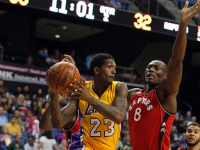 Lakers guard Louis Williams (left) looks to pass against Raptors forward Bismack Biyombo during their game last week. Biyombo has been turning heads in camp for how well he plays on the defensive end.