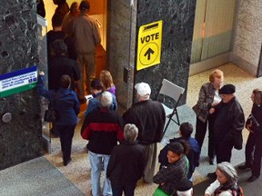 Voters assemble in a lineup stretching far outside the door to the polling station at City Hall on Oct. 10, 2015. 
SAM COOLEY/OTTAWA SUN