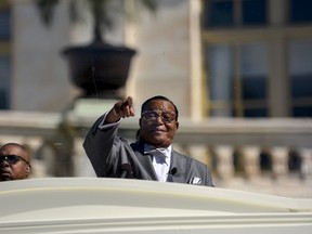 Nation of Islam leader Louis Farrakhan speaks from behind a layer of glass on the steps of the U.S. Capitol at a rally billed as "Justice or Else" to mark the 20th anniversary of the Million Man March on the National Mall in Washington October 10, 2015. The original Million Man March took place on October 16, 1995. REUTERS/James Lawler Duggan