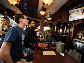 (left to right) Jason Chan and Jared Simpson watch the Edmonton Oilers hockey game at Hudsons, 10307 Whyte Ave., in Edmonton Alta. on Saturday Oct. 10, 2015.