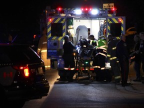 A Niagara Regional Police officer is loaded into an ambulance after being shot at a Fenwick apartment building Saturday October 10, 2015 in Pelham, Ont. (Greg Furminger/Welland Tribune)