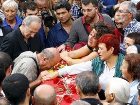 Family members of Korkmaz Tedik, a victim of Saturday's bomb blasts, mourn over his coffin during a funeral ceremony in Ankara, Turkey, October 11, 2015. Thousands of people, many chanting anti-government slogans, gathered in central Ankara on Sunday near the scene of bomb blasts which killed at least 95 people, mourning the victims of the most deadly attack of its kind on Turkish soil. REUTERS/Umit Bektas