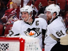 Sidney Crosby #87 and Phil Kessel #81 of the Pittsburgh Penguins celebrate after Kessel scored a second period goal against the Arizona Coyotes during the NHL game at Gila River Arena on October 10, 2015 in Glendale, Arizona.   Christian Petersen/Getty Images/AFP
