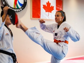 Kim McRae, right, a Canadian Olympic luger, practises her taekwondo skills with her coach Seoung Min Rim in Calgary, Alta., Tuesday, Oct. 6, 2015. (THE CANADIAN PRESS/Jeff McIntosh)