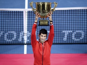 Novak Djokovic of Serbia raises his trophy during the award ceremony after winning the men's singles final match against Rafael Nadal of Spain at the China Open Tennis Tournament in Beijing on Oct. 11, 2015. (REUTERS/Stringer)