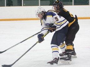 Laurentian Voyageurs' Ellery Veerman protects the puck against a Waterloo defender during OUA women's hockey action Saturday at Gerry McCrory Countryside Arena.