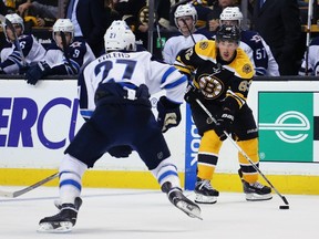 Brad Marchand of the Boston Bruins carries the puck against Nikolaj Ehlers of the Winnipeg Jets at TD Garden in Boston on Oct. 8, 2015. (Maddie Meyer/Getty Images/AFP)