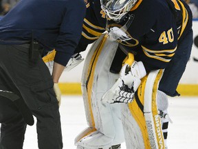 Buffalo Sabres goaltender Robin Lehner gets assistance from the Sabres' medical staff during a game against the Ottawa Senators in Buffalo on Oct. 8, 2015. ((AP Photo/Gary Wiepert)