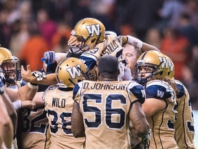 Casillo gets mobbed by his teammates on Saturday. (THE CANADIAN PRESS)