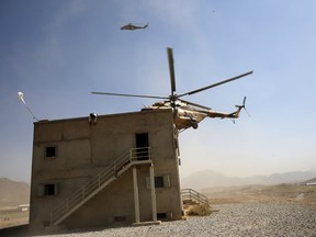 In this October 7, 2015 file photo, an Afghan National Army (ANA) helicopter approaches a building during a training exercise at the Kabul Military Training Centre in Afghanistan. (REUTERS/Ahmad Masood)