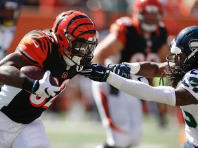 Cincinnati Bengals running back Jeremy Hill runs the ball against Seattle Seahawks cornerback Richard Sherman in the first half of an NFL football game on Oct. 11, 2015. (AP Photo/Gary Landers)