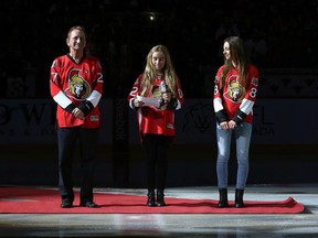 The Ottawa Senators took part in their home opener against the Montreal Canadians at Canadian Tire Centre in Ottawa Ontario Sunday Oct 11, 2015. Ottawa Senators owner Eugene Melnyk stands at centre ice with his daughters Olivia and Anna before Sunday's game.  Tony Caldwell/Ottawa Sun/Postmedia Network