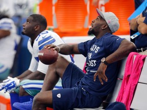 Dallas Cowboys' Dez Bryant, right, who is recovering from an injury, watches from the sideline during the first quarter of an NFL football game against the New England Patriots, Sunday, Oct. 11, 2015, in Arlington, Texas. (AP/Brandon Wade)