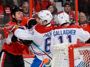 Marc Methot #3 of the Ottawa Senators roughs up Max Pacioretty #67 of the Montreal Canadiens during the NHL game at Canadian Tire Centre on October 11, 2015 in Ottawa, Ontario, Canada.  Minas Panagiotakis/Getty Images/AFP