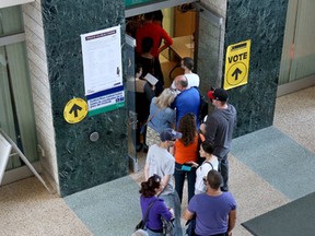 People gathered in line to vote at City Hall on Monday Oct 12, 2015. Advanced polling numbers were up, officials say, from the last election in 2011. 
Tony Caldwell/Ottawa Sun