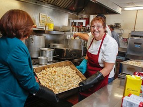 Martha's Table executive director Ronda Candy, left, helps one of the volunteer co-ordinators, Betty Ann Revelle. (Julia McKay/The Whig-Standard file photo)