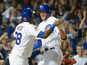 Kris Bryant #17 of the Chicago Cubs celebrates with Jorge Soler #68 of the Chicago Cubs after hitting a two-run home run in the fifth inning against the St. Louis Cardinals during game three of the National League Division Series at Wrigley Field on October 12, 2015 in Chicago, Illinois.   David Banks/Getty Images/AFP