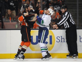 Ducks defenceman Clayton Stoner (left) fights against Canucks right wing Brandon Prust (right) during first period NHL action in Anaheim on Monday, Oct. 12, 2015. (Gary A. Vasquez/USA TODAY Sports)