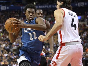 Timberwolves forward Andrew Wiggins (left) drives to the basket against the Raptors’ Luis Scola at the ACC Sunday night. (USA TODAY)