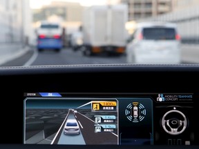 An onboard display monitor shows other vehicles as a staff member of Toyota Motor Corp drives its self-driving technology "Mobility Teammate Concept" prototype car hands-free on the Metropolitan Expressway during the Toyota Advanced Technologies media preview in Tokyo, Japan, October 8, 2015. (REUTERS)