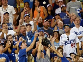 Fans attempt to catch a foul ball in the fourth inning in Game 2 of the National League Division Series at Dodger Stadium in Los Angeles on Oct. 10, 2015. (Sean M. Haffey/Getty Images/AFP)