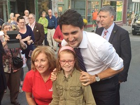 JEFF GARD/Northumberland TodayAfter stepping off his campaign bus, Liberal leader Justin Trudeau - along with Northumberland-Peterborough South candidate Kim Rudd - greeted eight-year-old Isla Robinson from Castleton.