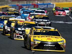 Carl Edwards, driver of the #19 Stanley Toyota, leads a pack of cars during the NASCAR Sprint Cup Series Bank of America 500 at Charlotte Motor Speedway in Charlotte, N.C., on Sunday, Oct. 11, 2015. (Sean Gardner/Getty Images/AFP)