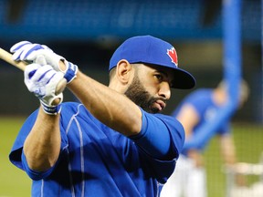 Jose Bautista swings outside the batting cage as the Toronto Blue Jays held an optional workout at the Rogers Centre in Toronto before Wednesday's Game 5 final against the Texas Rangers on Oct. 13, 2015. (Michael Peake/Toronto Sun/Postmedia Network)