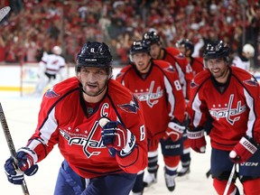 Capitals forward Alex Ovechkin (front) celebrates with teammates after scoring a goal against the Devils in Washington, D.C., on Oct. 10, 2015. (Patrick Smith/Getty Images/AFP)