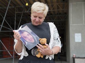 Outside of the London courthouse Ivana Broz clutches a photo of her son Jan and his favourite childhood toy, a stuffed bear named "Fuzz."  in London, Ont. on Tuesday October 13, 2015. Jan was killed in when the car he was  a passenger in crashed into a tree. The car's diver, Elton Sabino pleaded guilty to dangerous driving causing death.  (DEREK RUTTAN, The London Free Press)