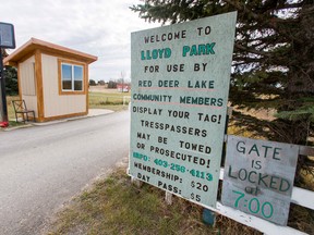 Stern words sit at the entrance to Lloyd Park in the Red Deer Lake area south of Calgary, Alta., on Tuesday, Oct. 13, 2015. Some people are upset with the Red Deer Lake Community Association for charging membership and day-rate fees for anyone using the park, claiming the area was meant to be open to the public, as per Devonian Group of Charitable Foundations standards. Lyle Aspinall/Calgary Sun/Postmedia Network