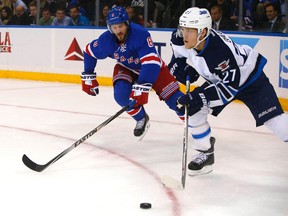 New York Rangers defenseman Kevin Klein (8) defends against Winnipeg Jets left wing Nikolaj Ehlers (27) during first period at Madison Square Garden.