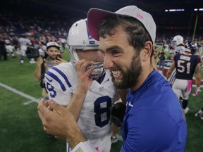 Colts injured quarterback Andrew Luck (right) celebrates with teammate Matt Hasselbeck after they defeated the Texans last week. Back in July, Luck was a 3-1 favourite to earn MVP honours. Now after his early-season struggles, he is at 50-1. (AP)