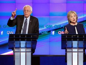 Hillary Rodham Clinton, right, and Sen. Bernie Sanders, of Vermont, speak during the CNN Democratic presidential debate Tuesday, Oct. 13, 2015, in Las Vegas. (AP Photo/John Locher)