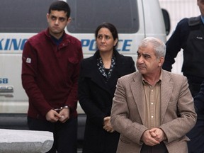 Mohammad Shafia, front, his wife Tooba Mohammad Yahya, centre, and their son Hamed arrive at the Frontenac County Courthouse in Kingston, Ont., on Jan. 26, 2012. (REUTERS/Lars Hagberg)