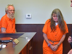 Bruce Leornard, left, and Deborah Leonard, centre, enter the courtroom of before their the arraignment Tuesday, Oct. 13, 2015 in New Hartford, N.Y.  (Mark DiOrio/Observer-Dispatch via AP)