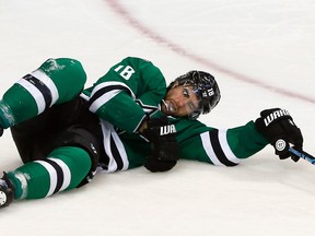 Patrick Eaves of the Dallas Stars falls to the ice after being hit by the puck in the third period against the Florida Panthers at American Airlines Center in Dallas on Feb. 13, 2015. (Tom Pennington/Getty Images/AFP)