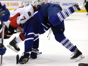 Toronto Maple Leafs' Nick Spaling gets knocked down against Ottawa Senators'  Kyle Turris at the Air Canada Centre in Toronto on Oct. 10, 2015. (Craig Robertson/Toronto Sun/Postmedia Network)