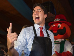 Liberal leader Justin Trudeau counts to three in German prior to tapping a keg during an Oktoberfest celebration in Kitchener, Ont., on Oct. 13, 2015. (THE CANADIAN PRESS/Paul Chiasson)